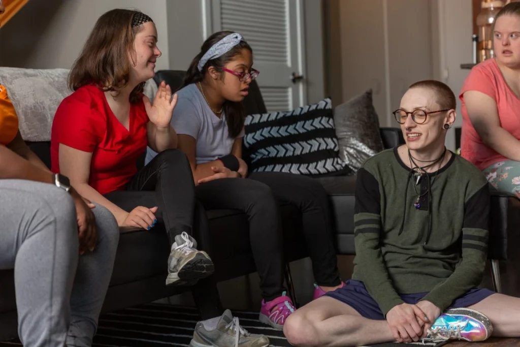 Group of disabled friends with down syndrome with support worker